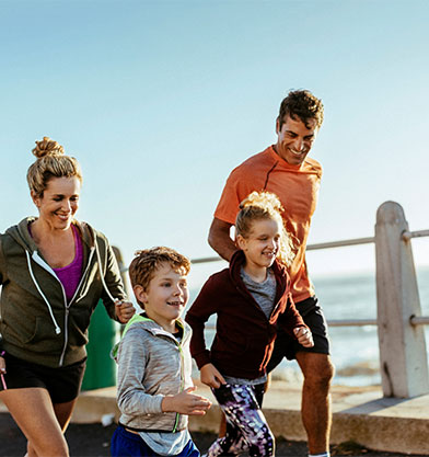 Happy family running at the beach